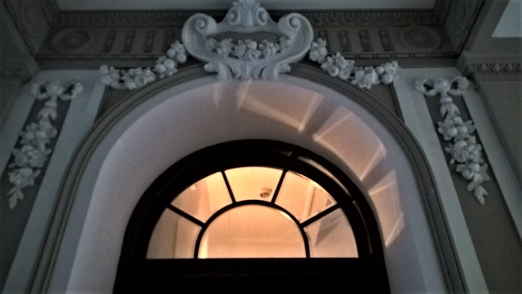 Oprawa nadświetla, wejście na główną klatkę schodową w budynku frontowym z przejazdu bramnego. Fot. Katarzyna Komar-Michalczyk, 2018, źródło: lapidarium detalu